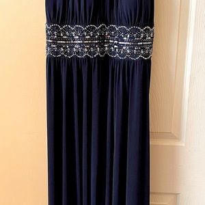 Woman full length gown. Slit up the front.  Beaded empire